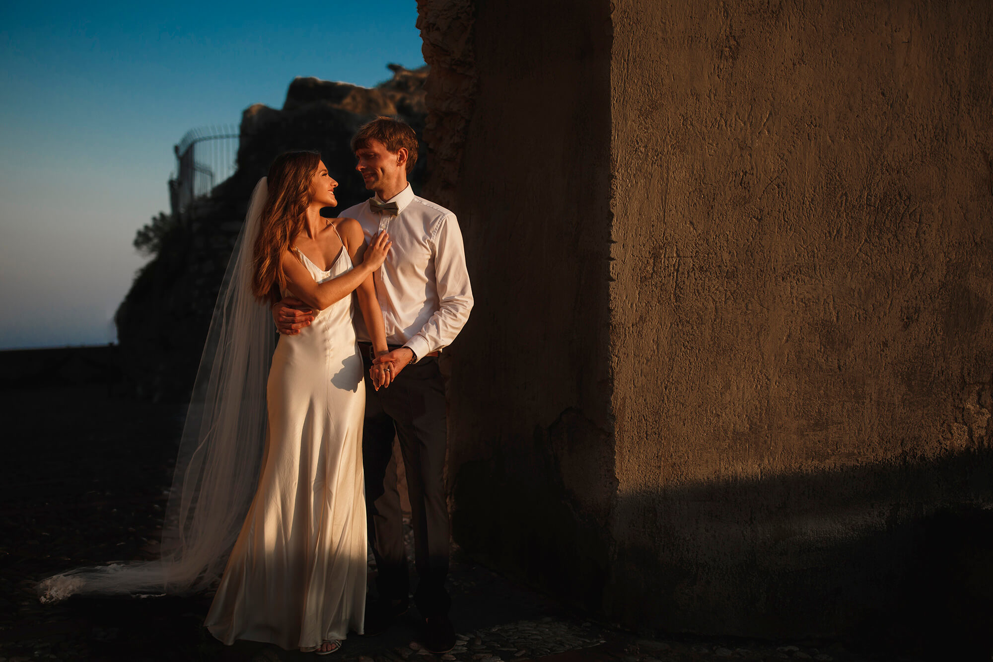 Newlyweds pose in the Taormina twilight.
