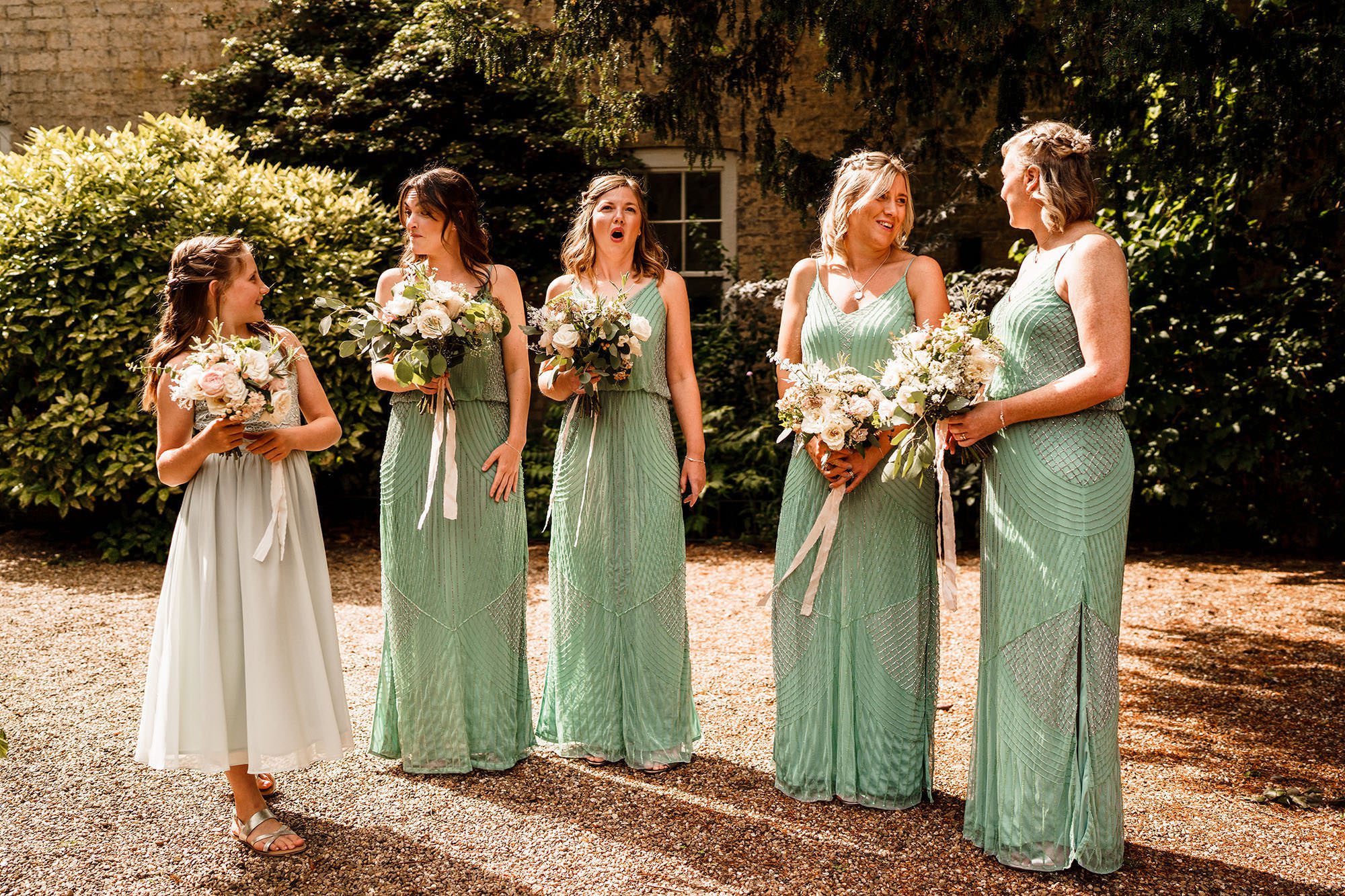 bridesmaids standing and waiting for the bride in The Cotswolds countryside