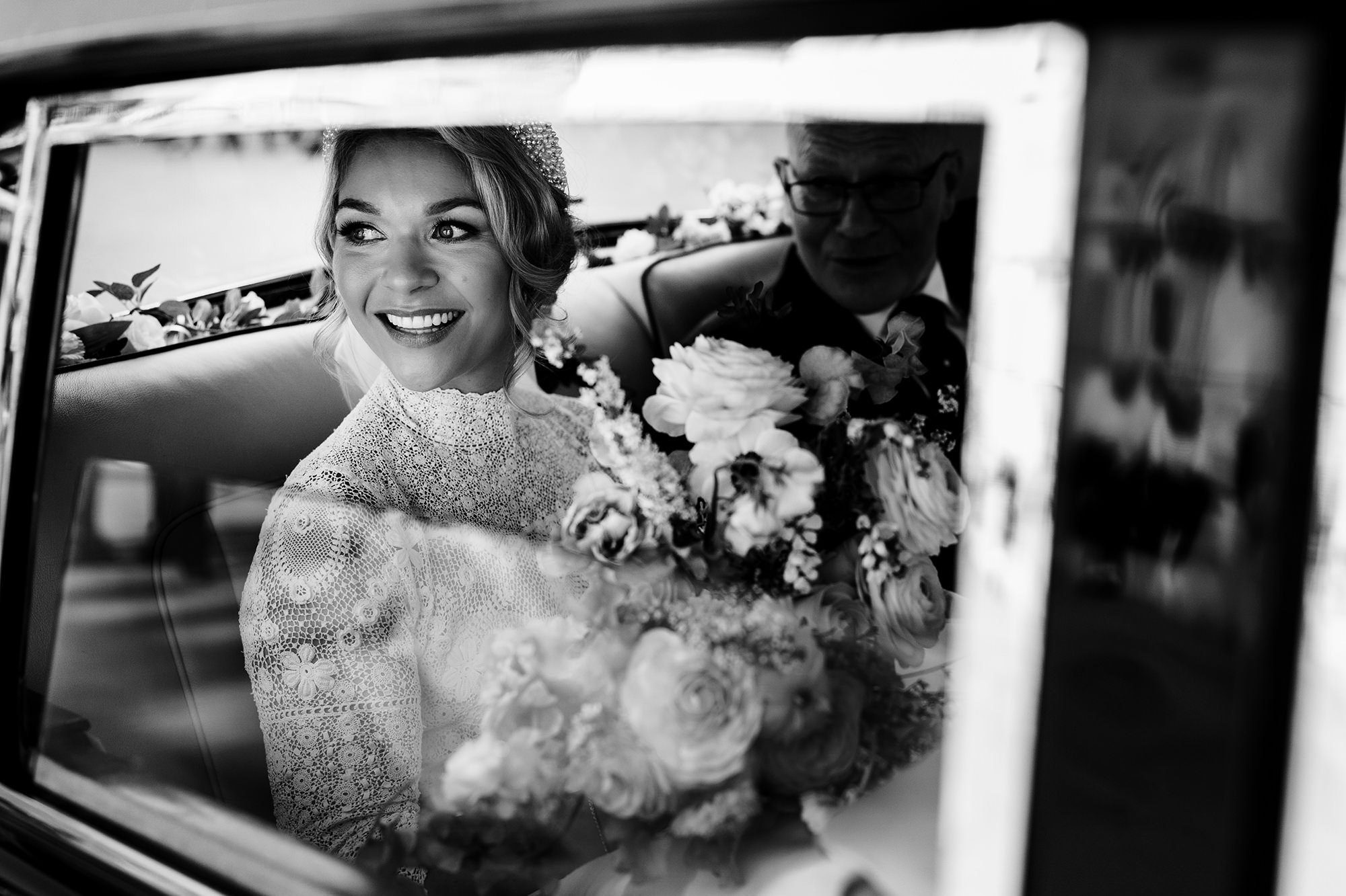 bride looks out of wedding care before her cumbrian wedding