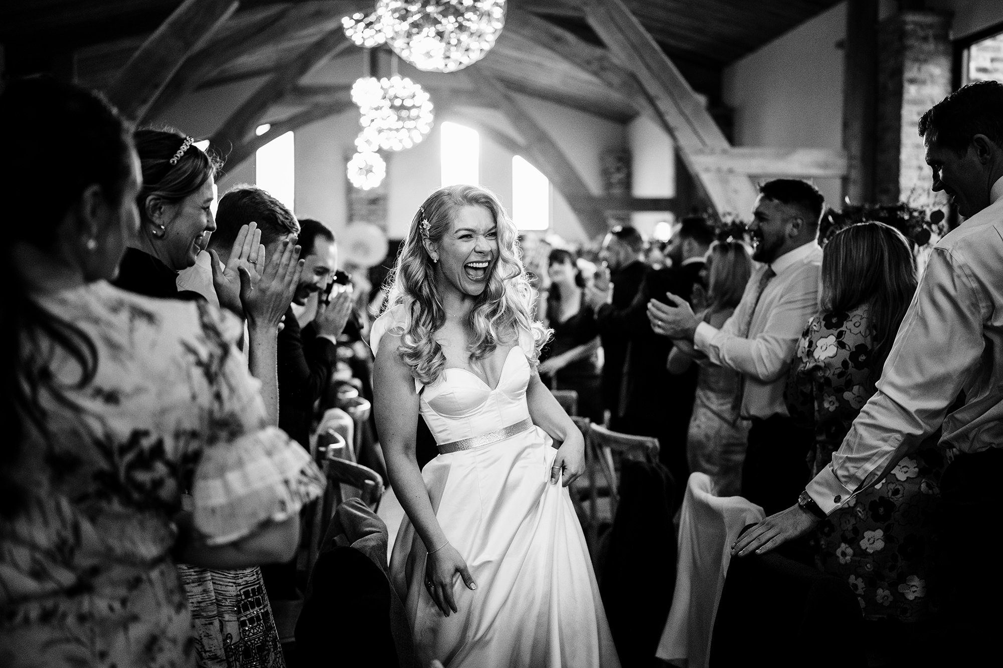 bride walks through her guests at lake district wedding