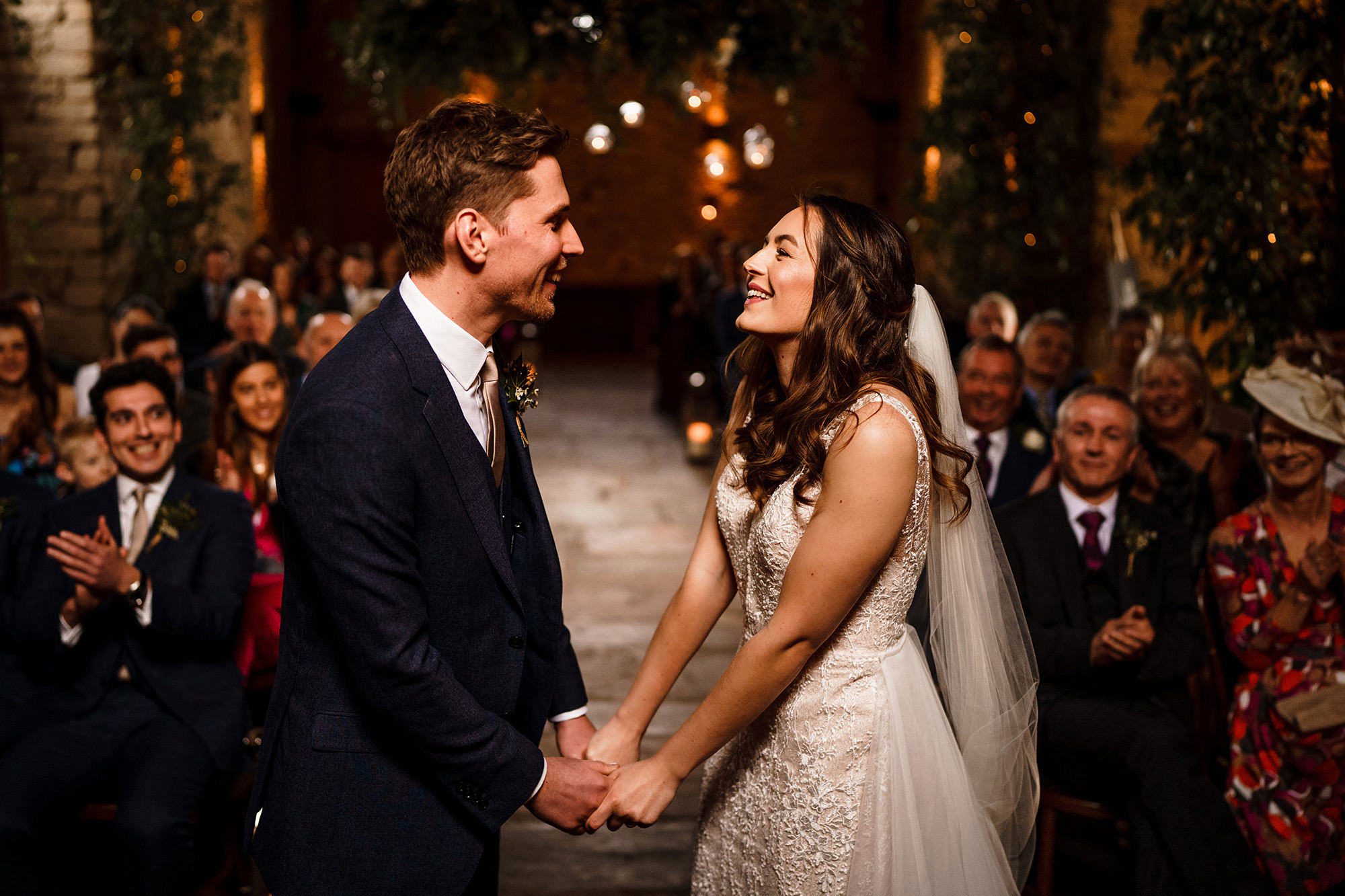 bride and groom smile at Lake District barn wedding