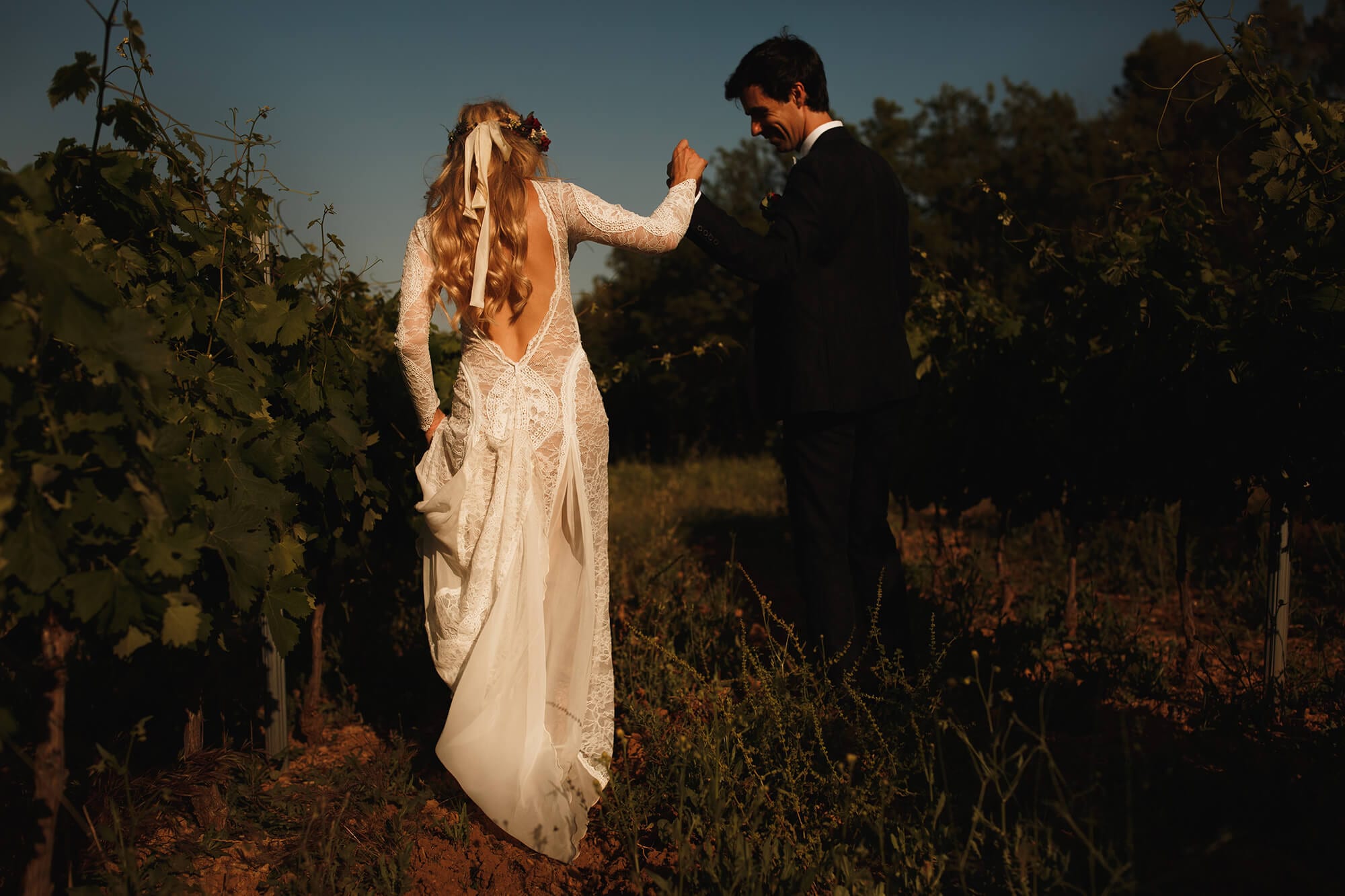 Bride and groom walking together in field France wedding