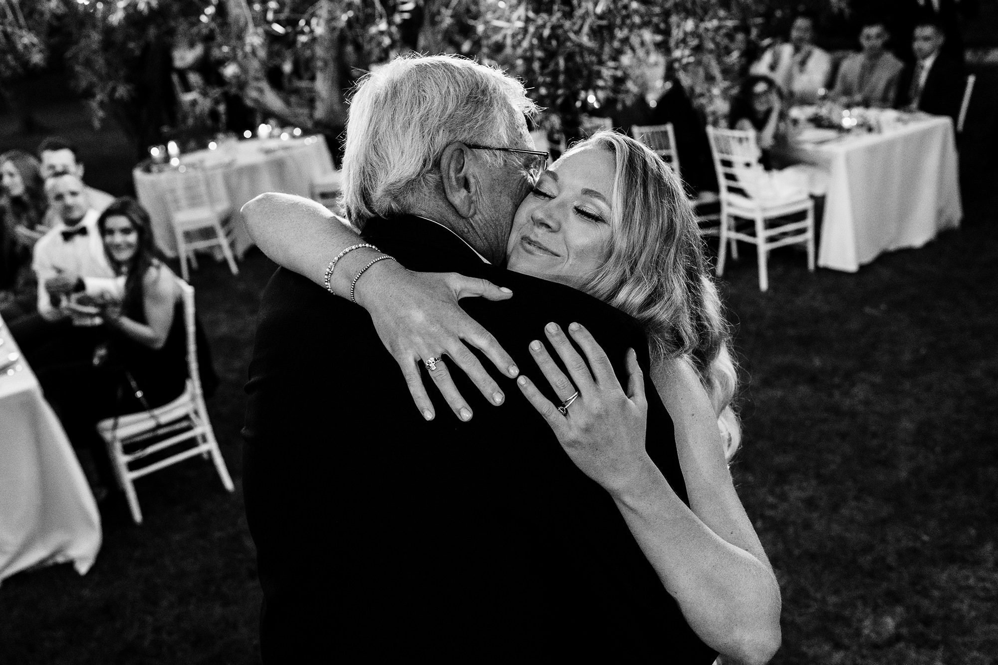Bride and her father embrace during Italian wedding reception in Sorrento.