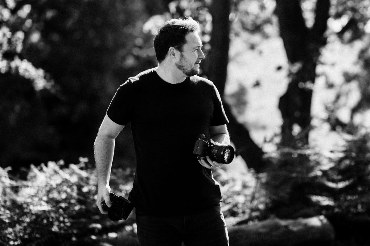 Stephen Walker standing with his cameras